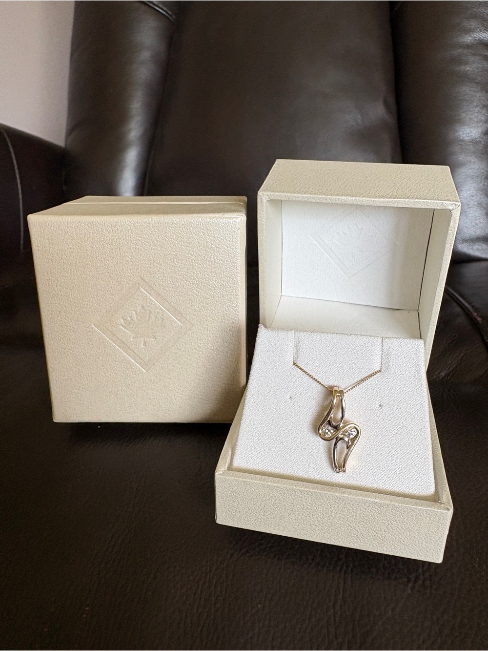 Diamond, Two-Tone Gold Ribbon Style Pendant Necklace.
Two Genuine Diamonds.